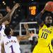 Michigan junior Tim Hardaway Jr. looks to pass around Kansas freshman Jamari Traylor and sophomore Naadir Tharpe during the second half at Cowboys Stadium in Arlington, Texas on March 29, 2013. Melanie Maxwell I AnnArbor.com